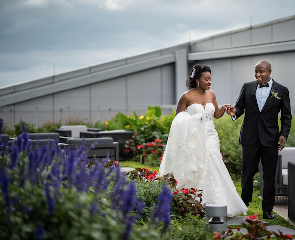 bride and groom in roof top garden - Philadelphia wedding - lounge furniture in a garden