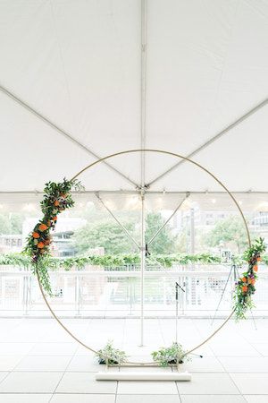 gold moon gate wedding arch decorated with purple and orange flowers at the Liberty View Ballroom