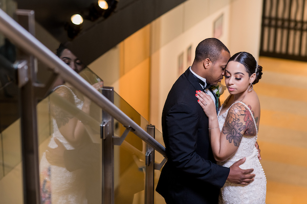 bride and groom staining on the stairs at the Hamilton Gallery in the Pennsylvania Academy for the Fine Arts