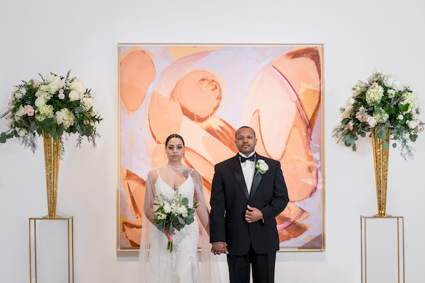 bride and groom in front of a modern work of art in PAFA's Hamilton Building
