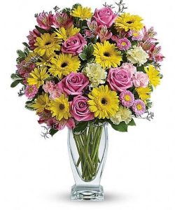 Clear vase with pastel flowers starting at $75.00